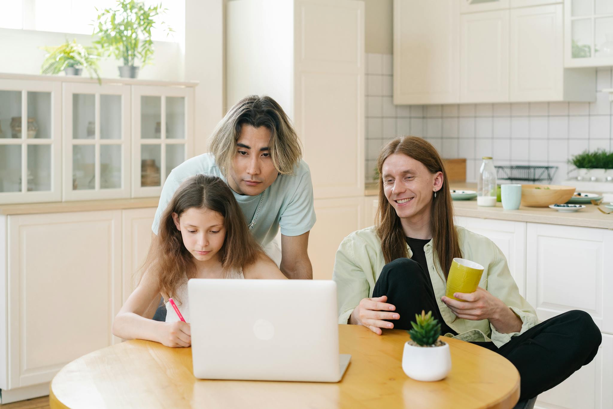 Family of three engaged in online activities at home with a diverse setting and warm ambiance.